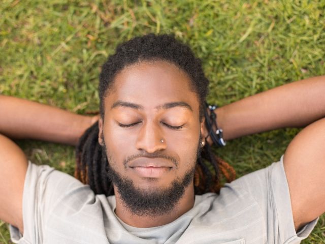 Handsome hipster relaxing in the park
